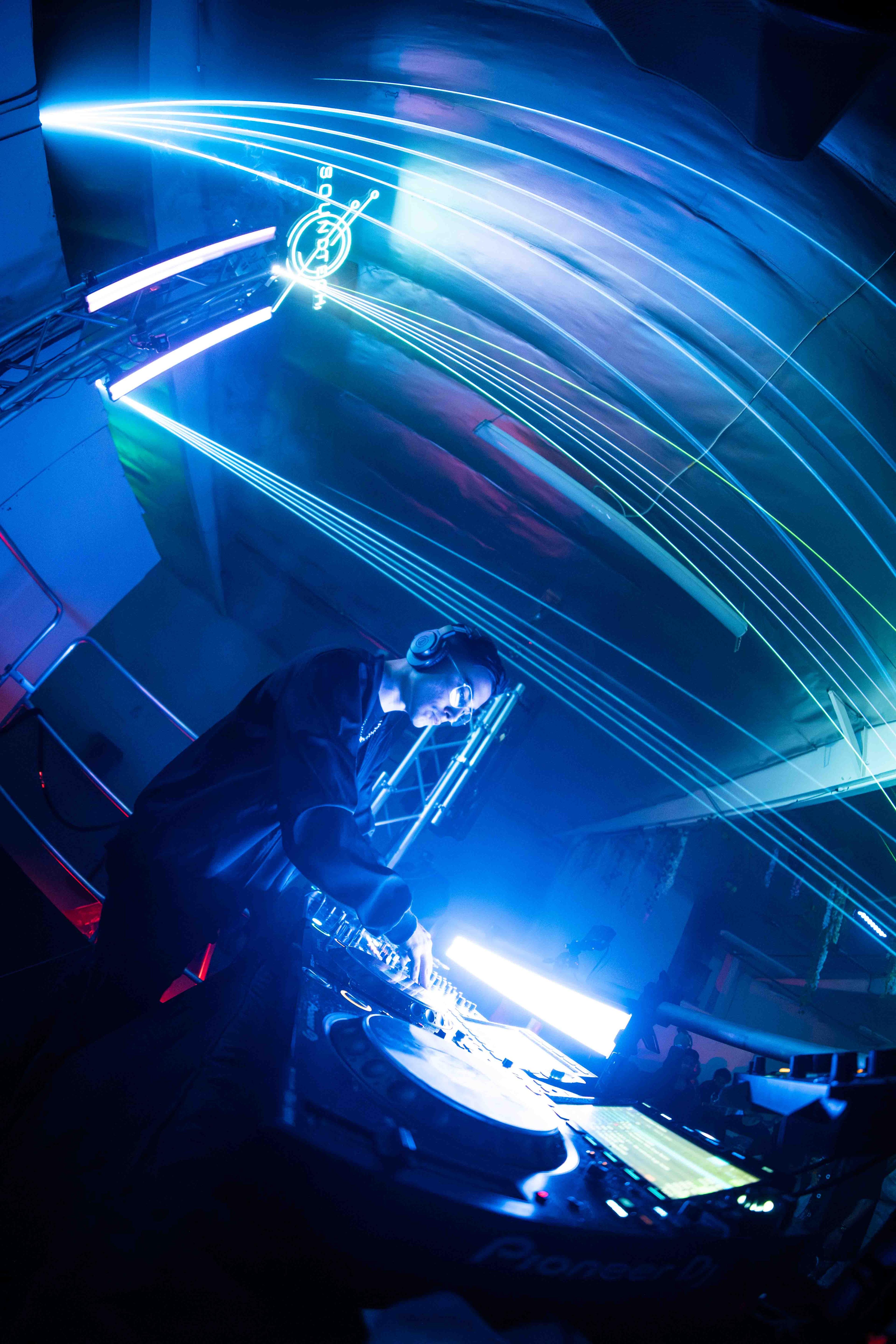 Intimate club show with performer inches from the front row crowd in dark venue