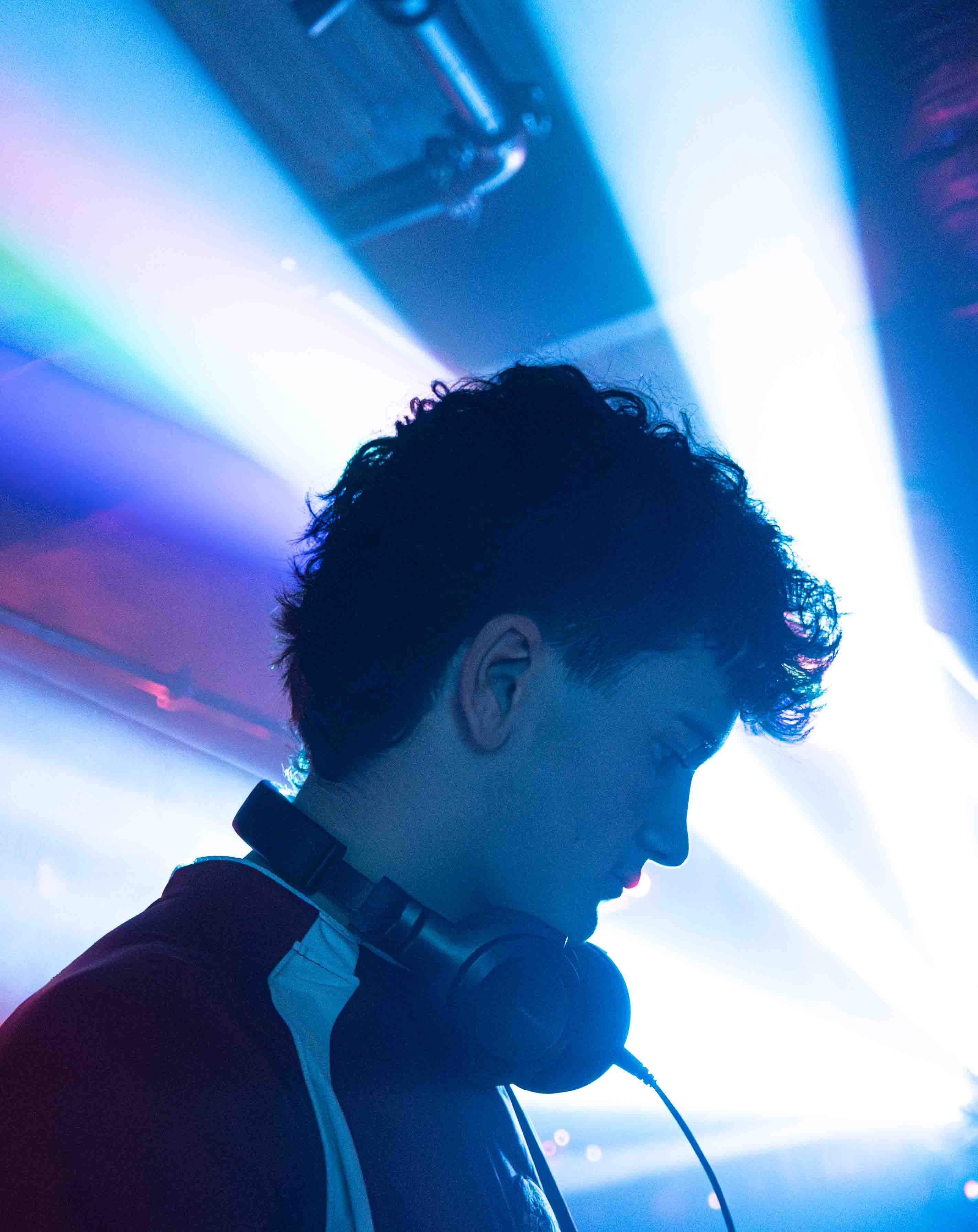 Sea of phone lights from the crowd creating a galaxy effect in a dark arena